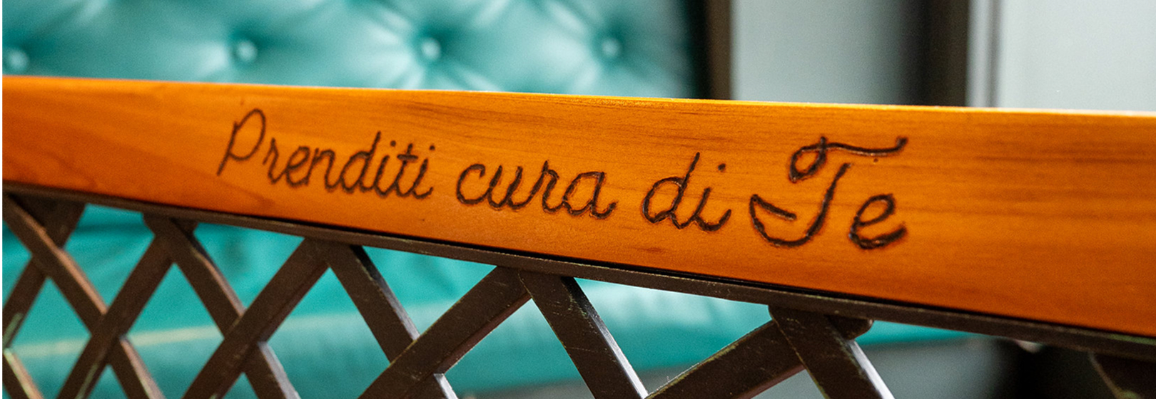 la frase "prenditi cura di te" è incisa a pirografo su un panchina di legno